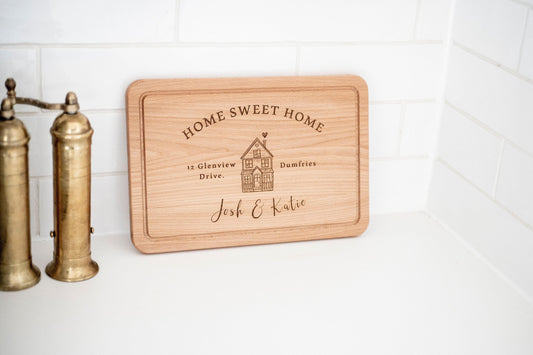 Personalized wooden cutting board with "Home Sweet Home" engraving by Custom Chic, perfect as a housewarming or new home gift.