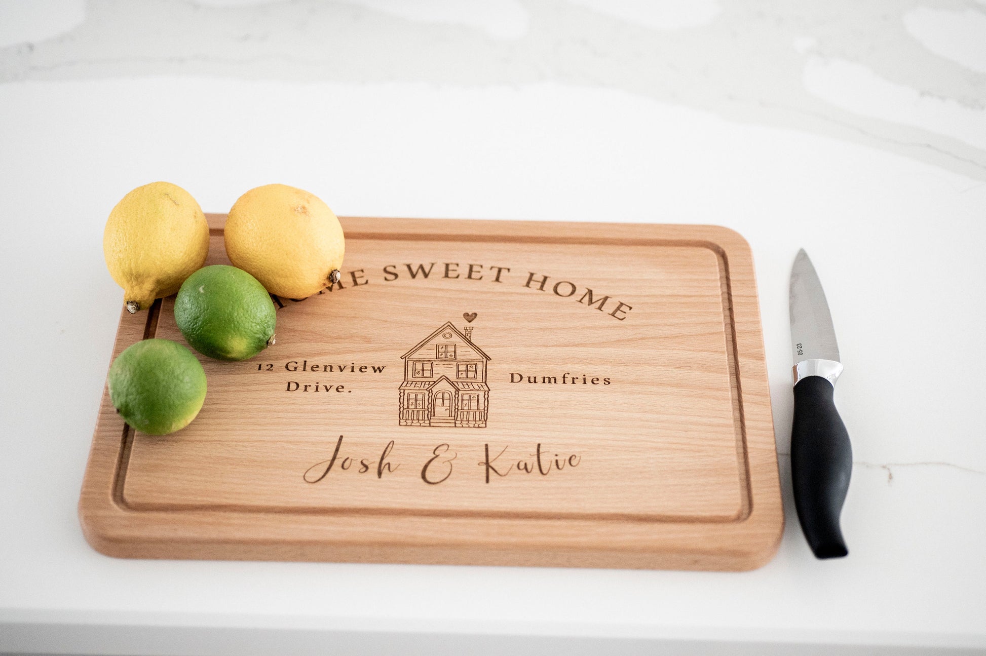 Personalized wooden cutting board with "Home Sweet Home" design, perfect for housewarming or Christmas gift from Custom Chic.