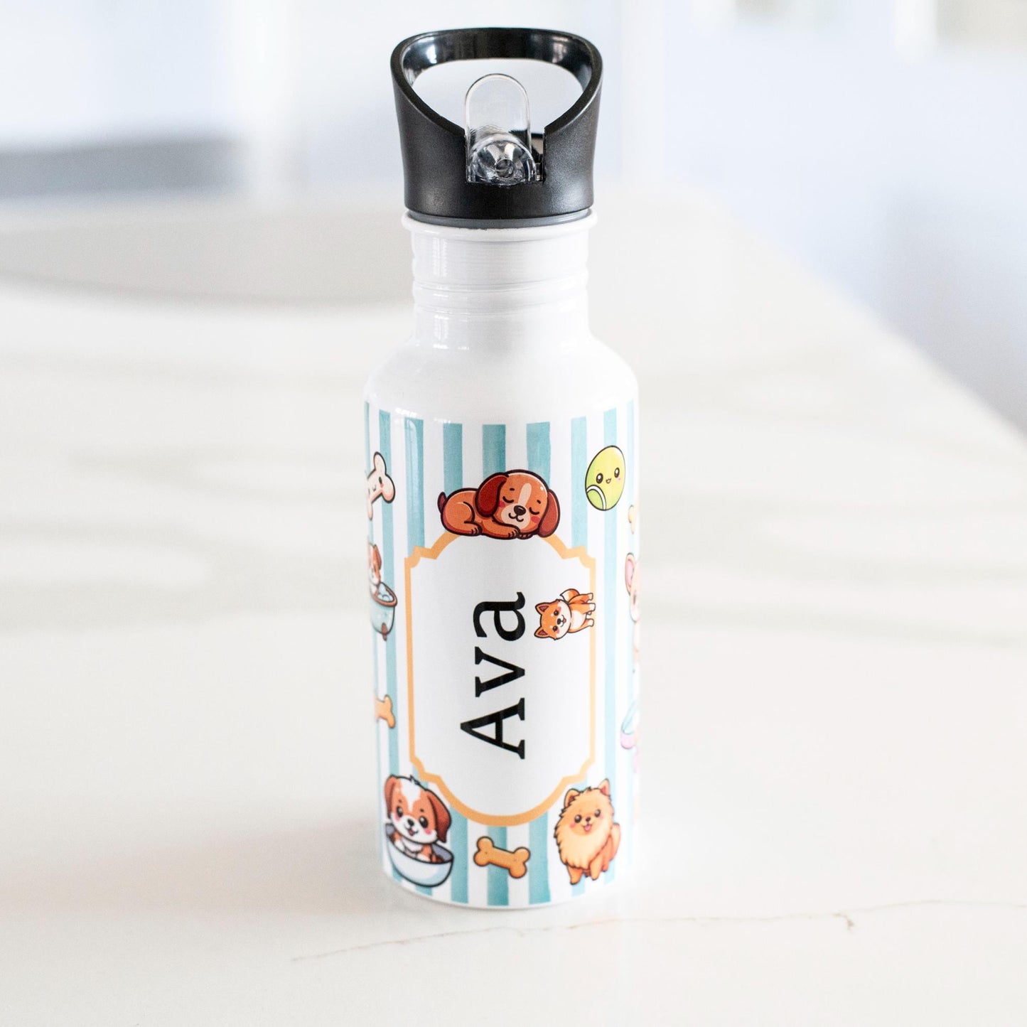 Personalized water bottle with cartoon designs and name 'Ava' on a white surface.